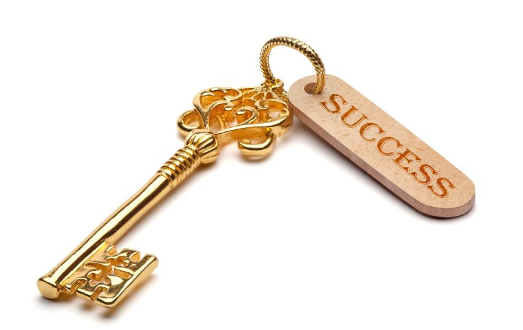 Golden key to success, isolated on the white background, clipping path included.